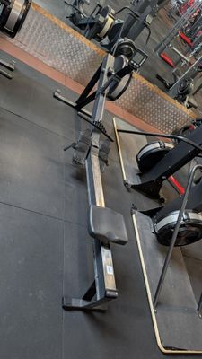 a row of stationary exercise bikes in a gym