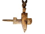 a wooden object with a bird on top of it
