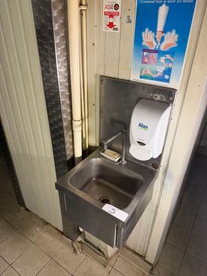 a sink and a toilet in a public restroom