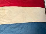 a large red, white and blue flag on a table