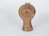 a close up of a wooden object with a face on it