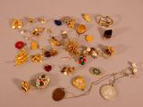 many different types of jewelry on a white surface
