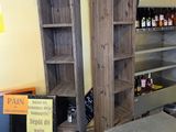 many shelves in a store with bottles of wine on them
