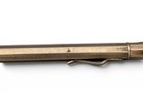 a close up of a pen on a white surface with a white background