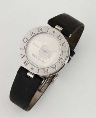 an image of a close up of a wrist watch on a white surface