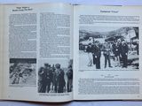 an open book with a picture of a group of people standing in front of a plane