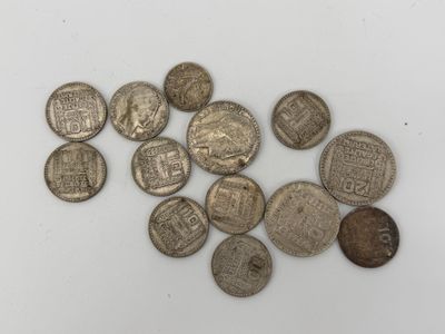 a pile of silver coins sitting on top of a white surface