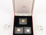 two gold and silver coins in a red box on a white surface
