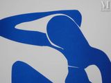 a blue and white sign with a woman in a bikini on it