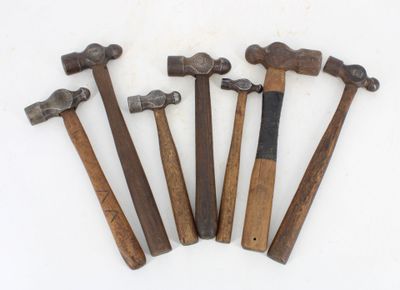six hammers are lined up on a white surface with a white background