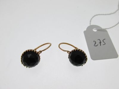 a pair of black glass earrings on a white background