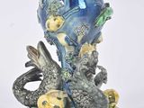 a blue vase with fish on it on a white background