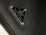 the black purse has a triangle shaped logo on the front of it
