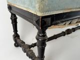 a small foot stool with a blue cushion on top of it