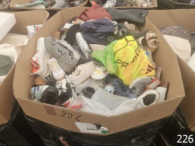 a cardboard box filled with shoes and other items