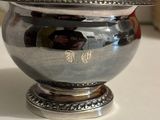 a silver bowl sitting on top of a table