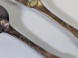 two spoons that are sitting on a table