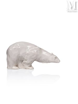 a white polar bear figurine sitting on a white surface