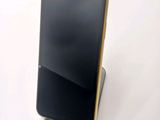 a cell phone that is sitting on top of a stand
