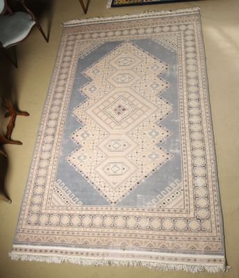 an image of a rug on the floor with a chair in the background