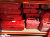 many red plastic containers sitting on a shelf in a store
