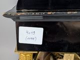 a black and gold clock sitting on top of a table
