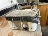 a piece of metal sitting on top of a wooden table