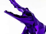 un origami violet représentant un crocodile la gueule ouverte