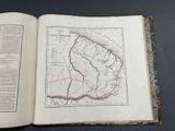 an open book with a map on it on a table