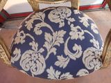 a chair with a blue and white cushion on it