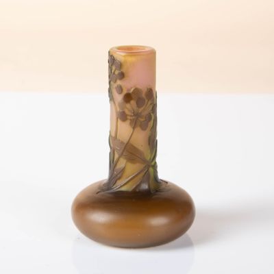 a small vase with a design on it on a white surface