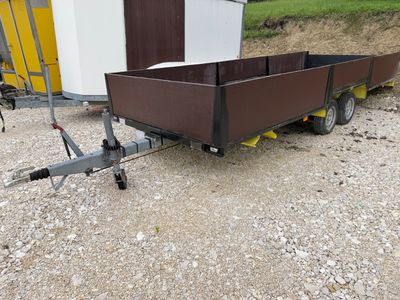 a trailer with a trailer attached to it in the dirt
