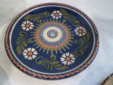 a plate with a design on it sitting on a table
