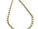 a close up of a gold beaded necklace on a white background
