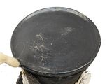 a black pot with a wooden handle sitting on a table