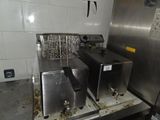 two deep fryers sitting on a counter in a kitchen