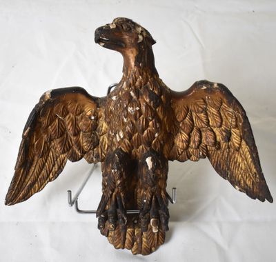 a statue of an eagle that is sitting on a hook
