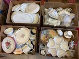 boxes filled with assorted dishes and plates sitting on a floor