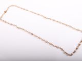 a close up of a gold chain with a white background
