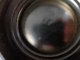 a close up of a silver plate with a silver lid
