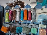 many different colored yarns on a rack in a store