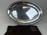 a silver tray with a mirror on top of it