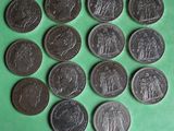 a bunch of coins sitting on top of a green surface