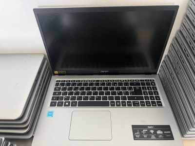 a laptop computer sitting on top of a stack of books