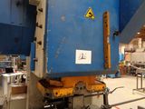 a picture of a machine in a factory with a sign on it
