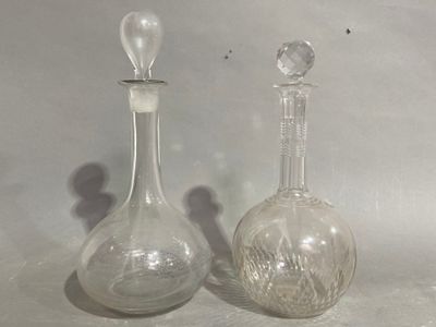 two glass vases sitting next to each other on a table