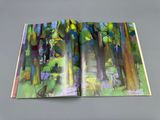 a picture of an open book with a picture of a forest