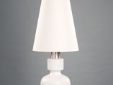 white table lamp with a white shade on top of it
