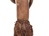 wooden statue of a man standing with a cane in his hand