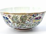 a white bowl with a dragon and flowers design on it